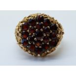 A 9ct gold ring set with a garnets in a cluster (size N)