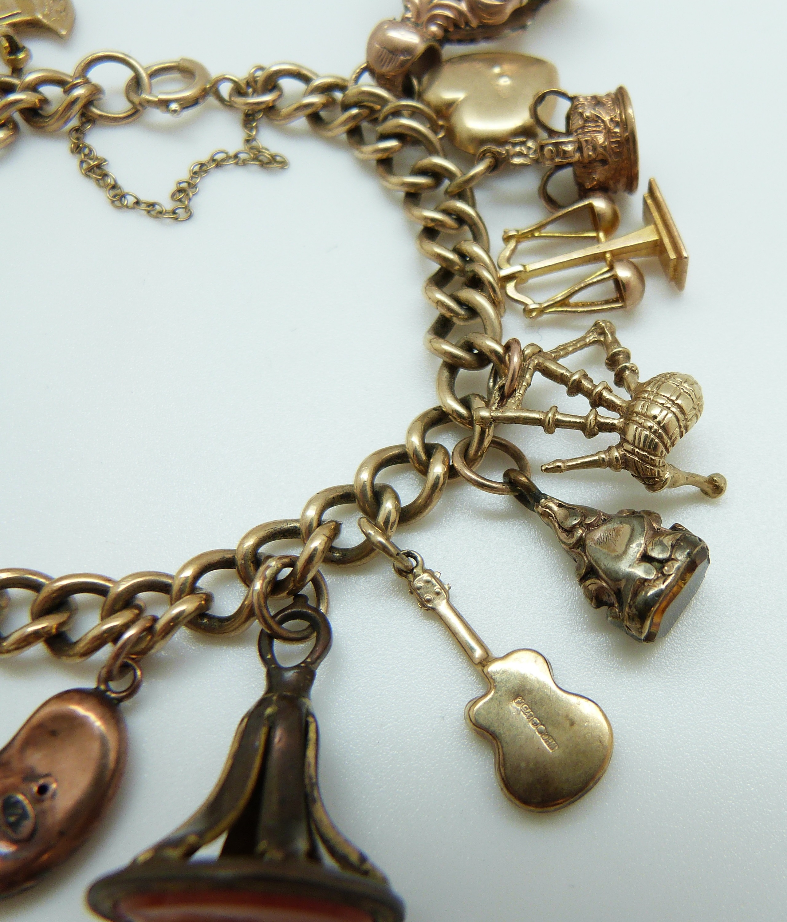 A 9ct gold charm bracelet with eleven 9ct gold charms including a crown, St Christopher, purse, - Image 6 of 8