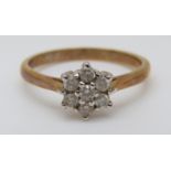 An 18ct gold ring set with diamonds in a cluster, total diamond weight approximately 0.25ct, 2.