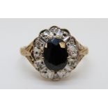 A 9ct gold ring set with a sapphire surrounded by diamonds (size L)