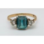 An 18ct gold ring set with an emerald cut blue topaz and two diamonds (size K)