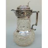 An Edward VII hallmarked silver mounted cut glass claret jug with pierced thumb piece,