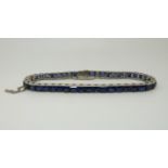 A Dreicer & Co white metal tennis bracelet set with 45 sapphires in square/rectangular step cut,