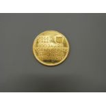 An Austrian gold coin commemorating 100 years of industry in Vorarlberg,