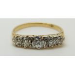An 18ct gold ring set with five graduated diamonds, centre diamond approximately 0.