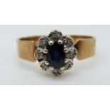 A 9ct gold ring set with a sapphire surrounded by diamonds (size M)