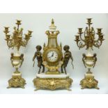 An ormolu and marble French style clock garniture, the German movement striking on a gong,