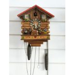 A c1950s Black Forest cuckoo clock by Kianec with Alpine lodge decoration to case,