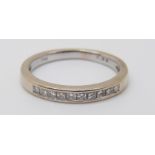 An 18ct white gold half eternity ring set with square cut diamonds totalling approximately 0.2ct, 2.