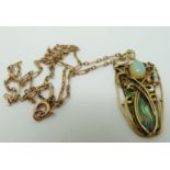 An Art Nouveau yellow metal necklace set with a piece of abalone to the ground and an opal cabochon