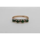 A 9ct gold ring set with emeralds and diamonds (size L)