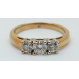 An 18ct gold ring set with three diamonds, total 0.