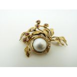 A Givenchy 14k gold brooch set with a central mabe pearl with a crescent of diamonds,