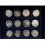 Twelve silver commemorative Ships and Explorers crown sized etc coins in a collector's case,