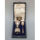 A cased Elkington hallmarked silver christening set together with a silver napkin ring,
