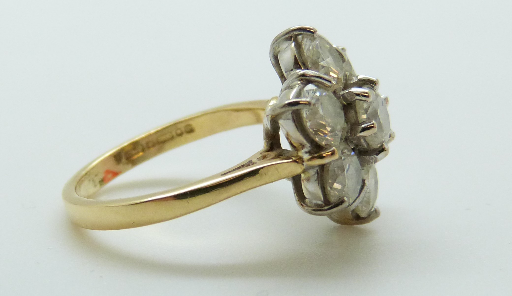 An 18ct gold ring set with seven round brilliant cut diamonds in a cluster, - Image 6 of 6