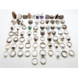 Seventy silver rings including examples set with paste, marcasite, tiger's eye, topaz,