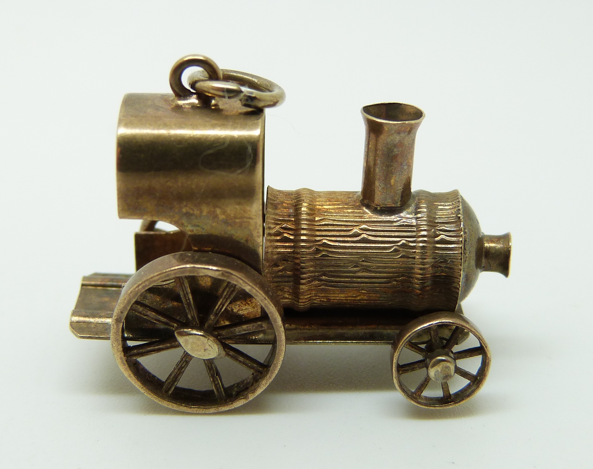 A 9ct gold charm or pendant in the form of a train, 5.