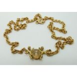 A 9ct gold necklace set with a crystal sphere and two cherubs signed to the back