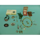 A collection of costume jewellery including a lacquer brooch, silver earrings,