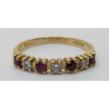 An 18ct gold ring set with alternating diamonds and rubies (size L)