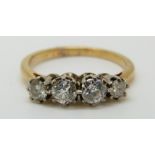 An 18ct gold ring set with four diamonds, total diamond weight approximately 0.