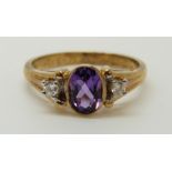 A 9ct gold ring set with an amethysts and diamonds (Size N/M)