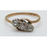 A 9ct gold ring set with three diamonds in a platinum twist setting, 2.