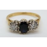 An 18ct gold ring set with a sapphire of approximately 0.5ct and two diamonds totalling 0.