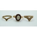 Three 9ct gold rings, one set with an opal surrounded by garnets, 4.