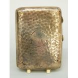 A hallmarked silver cigarette case with hammered decoration, Chester 1918,