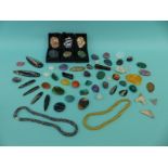 A collection of gemstones including jet, hematite, jade, agate, jasper,