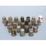 A collection of hallmarked silver and other thimbles comprising 11 hallmarked silver examples