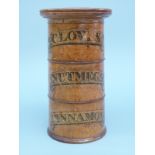 A turned treen three tier spice container labelled Cloves, Nutmeg and Cinnamon,