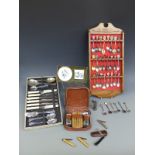 A collection of teaspoons in display stand, smoker's knives, gents wash set,