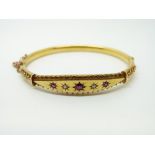 A 15ct gold bangle set with garnets and seed pearls, Chester 1906, 9.