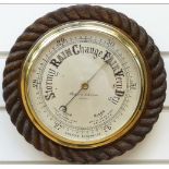 Negretti & Zambra of London barometer in oak rope twist surround,