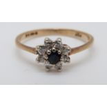 A 9ct gold rings set with a sapphire surrounded by diamonds in a cluster (size I)