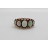 A 9ct gold ring set with five graduated opal cabochons and diamonds,