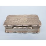 A George V hallmarked silver snuff box with shaped edge and engine turned decoration,