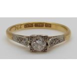 An 18ct gold ring set with a diamond of approximately 0.