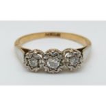 An 18ct gold ring set with three diamonds in a platinum star setting, 2.