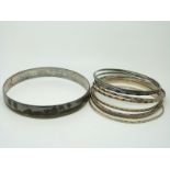 Nine silver bangles and a large silver niello flapper bangle