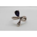 An 18ct white gold ring set with a pear cut tanzanite and a pear cut diamond (size I)