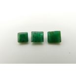 An emerald cut emerald of approximately 0.5ct and two square cut emeralds approximately 0.