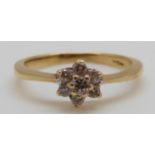 An 18ct gold ring set with diamonds in a cluster, 2.