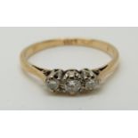 An 18ct gold ring set with three diamonds, 1.