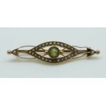 A 9ct gold Edwardian brooch set with a peridot and seed pearls 4.3cm, 2.