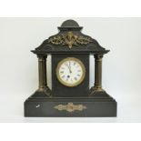 A Victorian slate mantel clock with Romanesque architectural case,