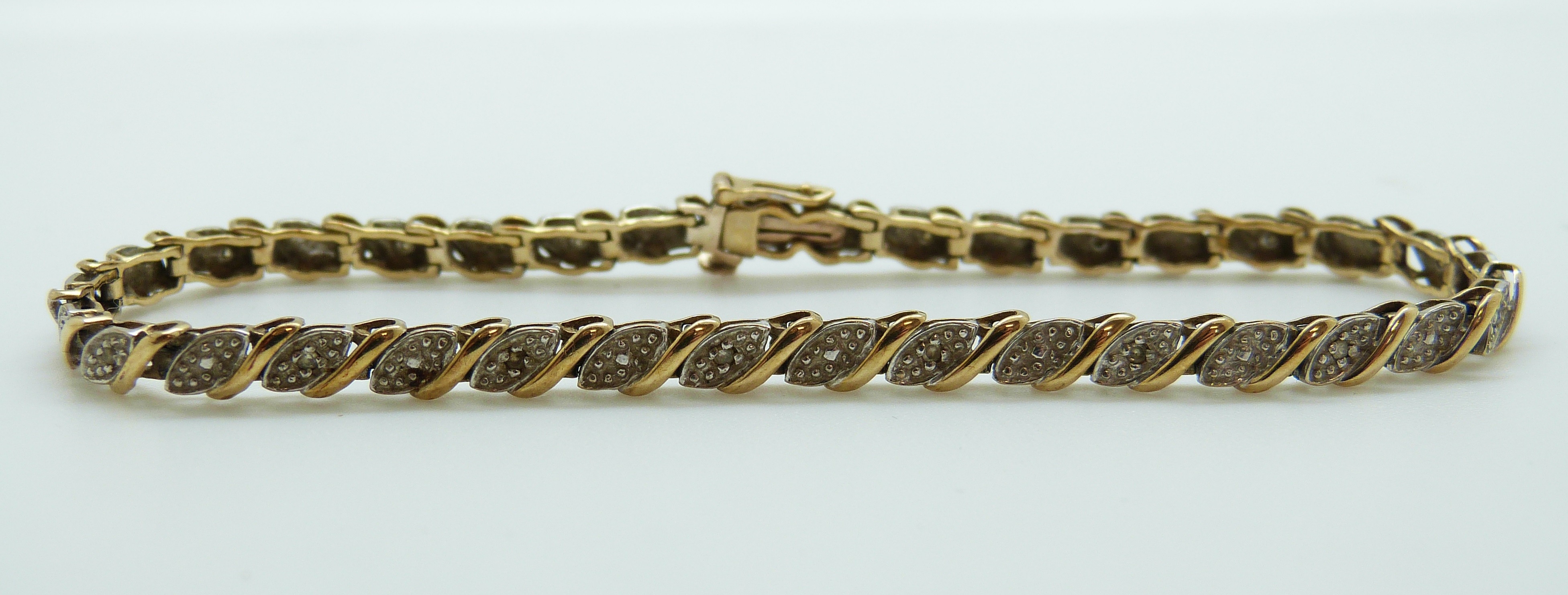 A 9ct gold bracelet set with diamonds, 7.